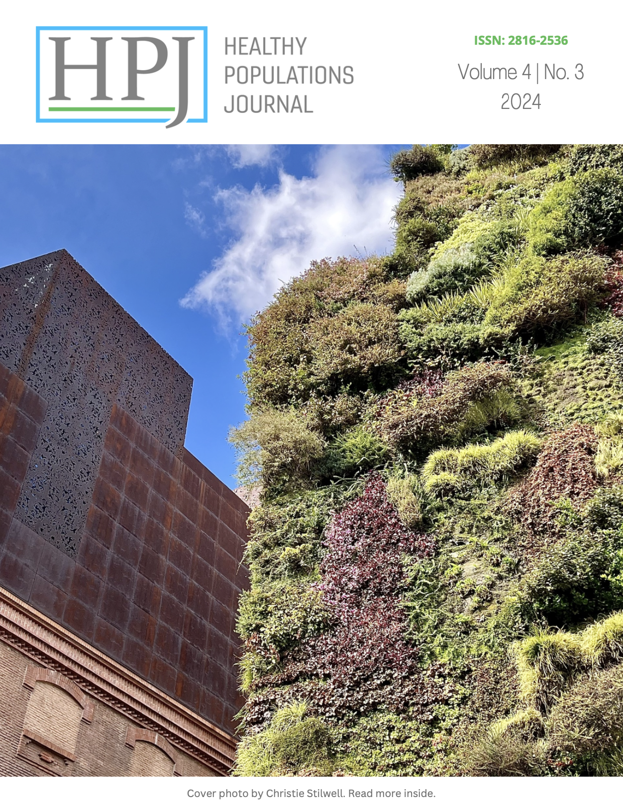 The cover photo has two buildings; on the right the building is a mixture of old brick and new metal, the building to the left is covered in green plants.